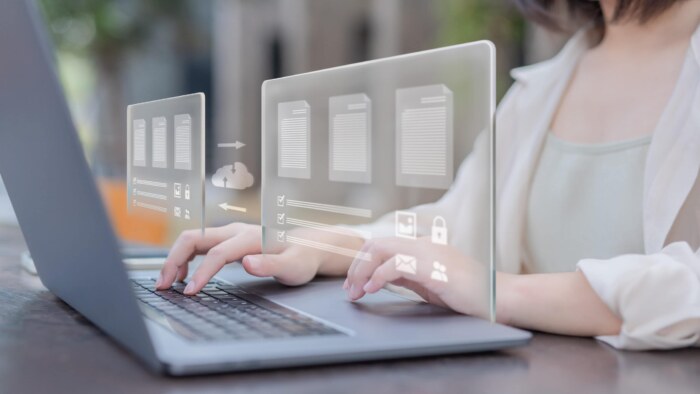 Businesswoman using futuristic digital interface for data management.