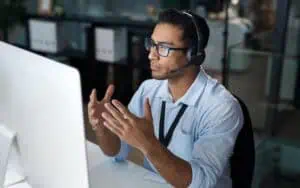 Business professional discussing IT staff augmentation strategies at a computer.