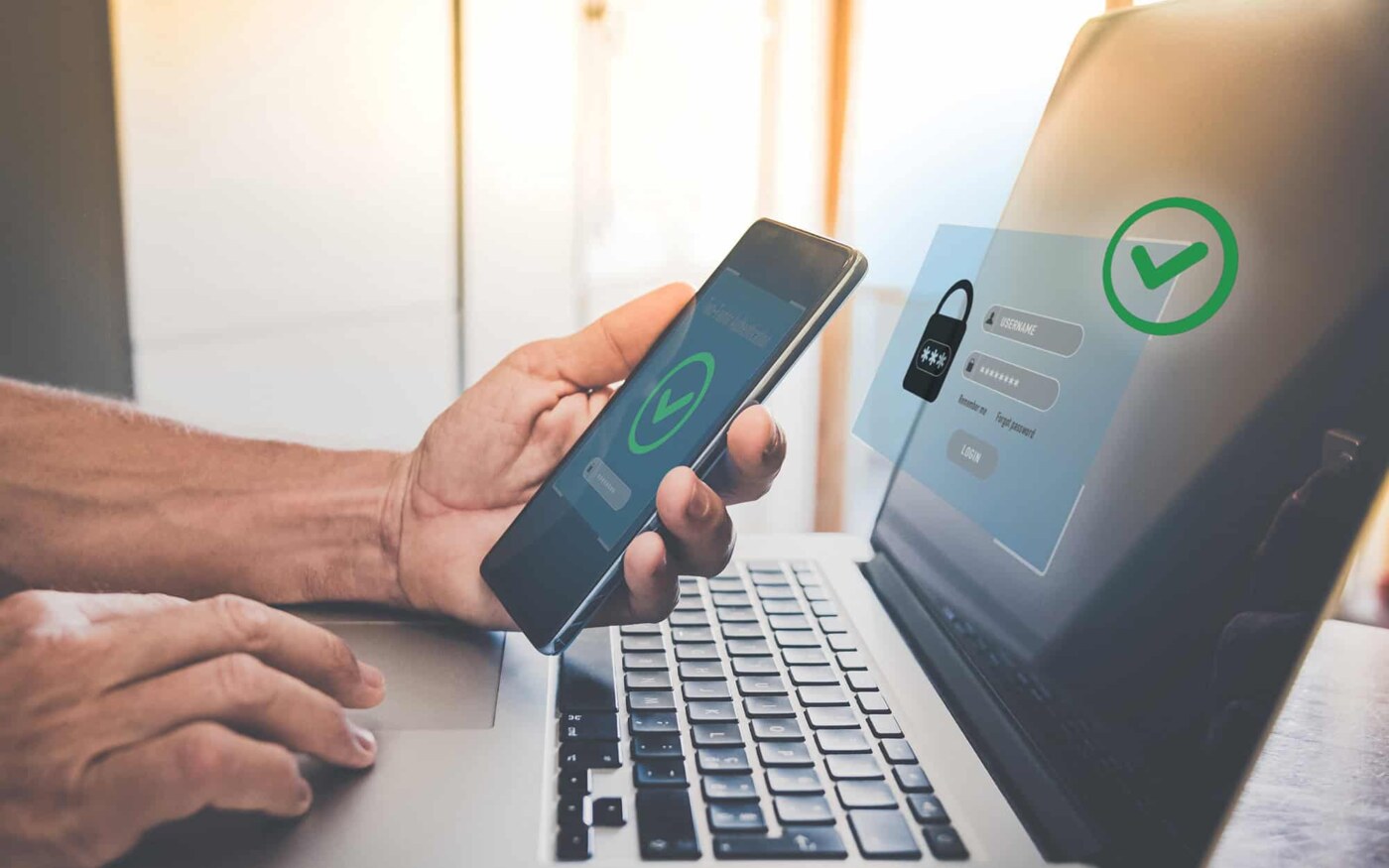 Person authenticating identity using a smartphone and laptop for secure access.