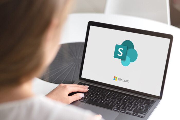 Microsoft SharePoint logo on a laptop screen for collaboration and document management.
