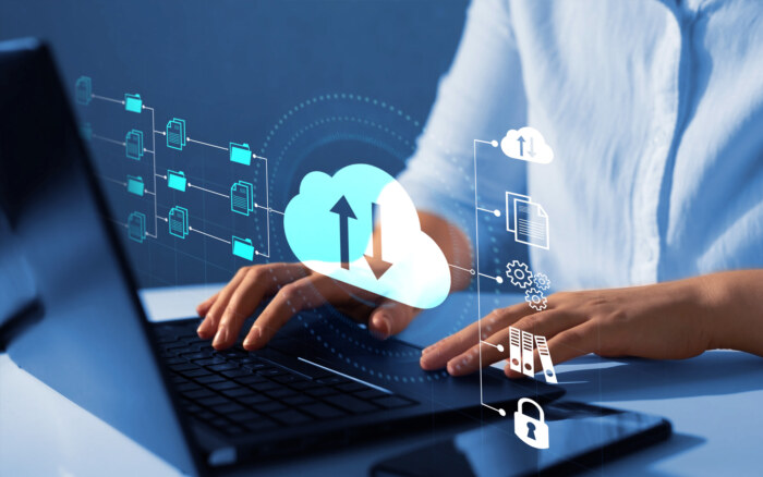 Cloud data management and migration icons with a person using a laptop.