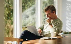 Business professional using laptop for Excel and Power Platform comparison.