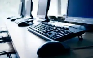 Office computers with keyboards and monitors for SharePoint workflow management.