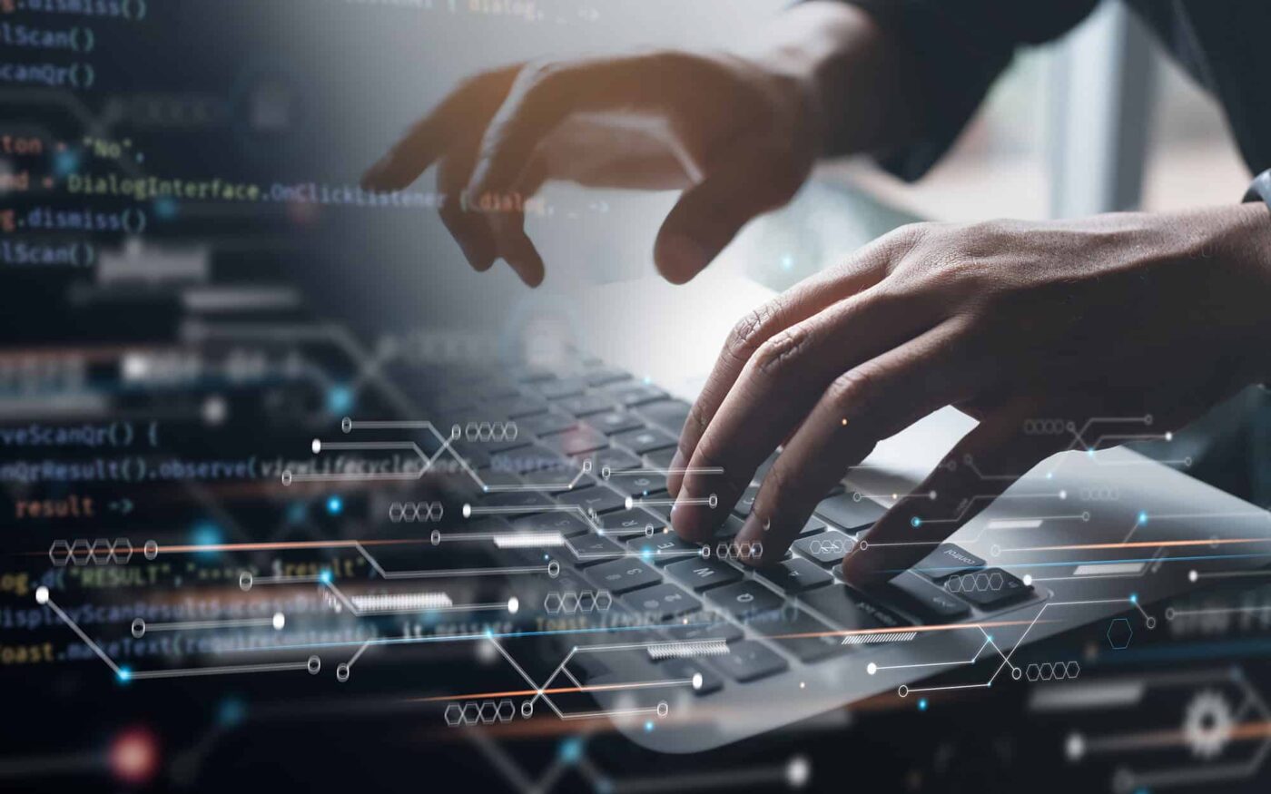 Hands typing on a laptop with digital data overlays representing Microsoft Dynamics 365 features.