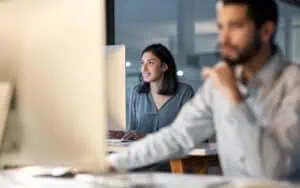 Team working on Microsoft 365 security standards in a modern office setting.