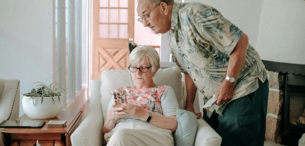 Elderly couple looking at phone