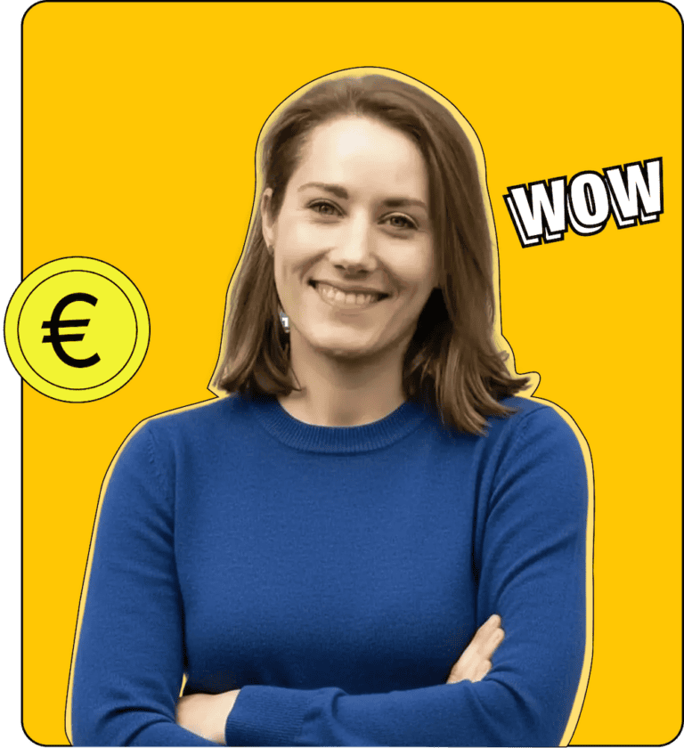 Nina hat die Arme verschränkt und lacht in die Kamera. Sie hat braune, mittellange Haare und blaue Augen. Neben ihr ist ein Geldstück zu sehen