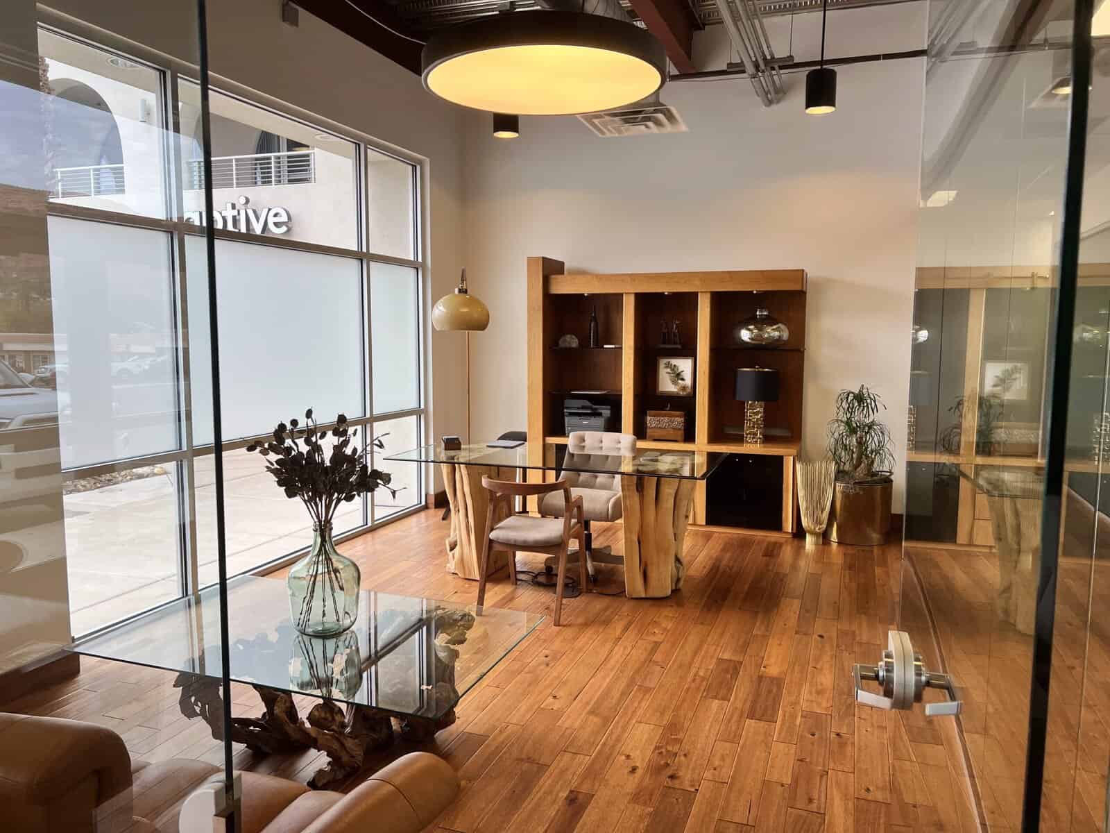 Modern medical clinic reception area with wooden accents and large windows.