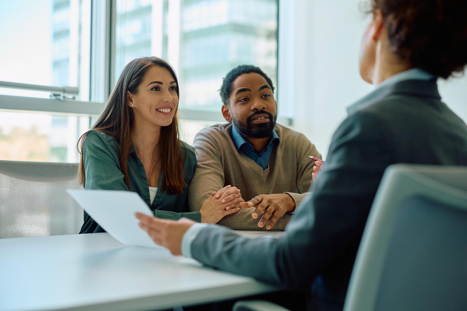 Business owners discussing insurance renewal questions with advisor.