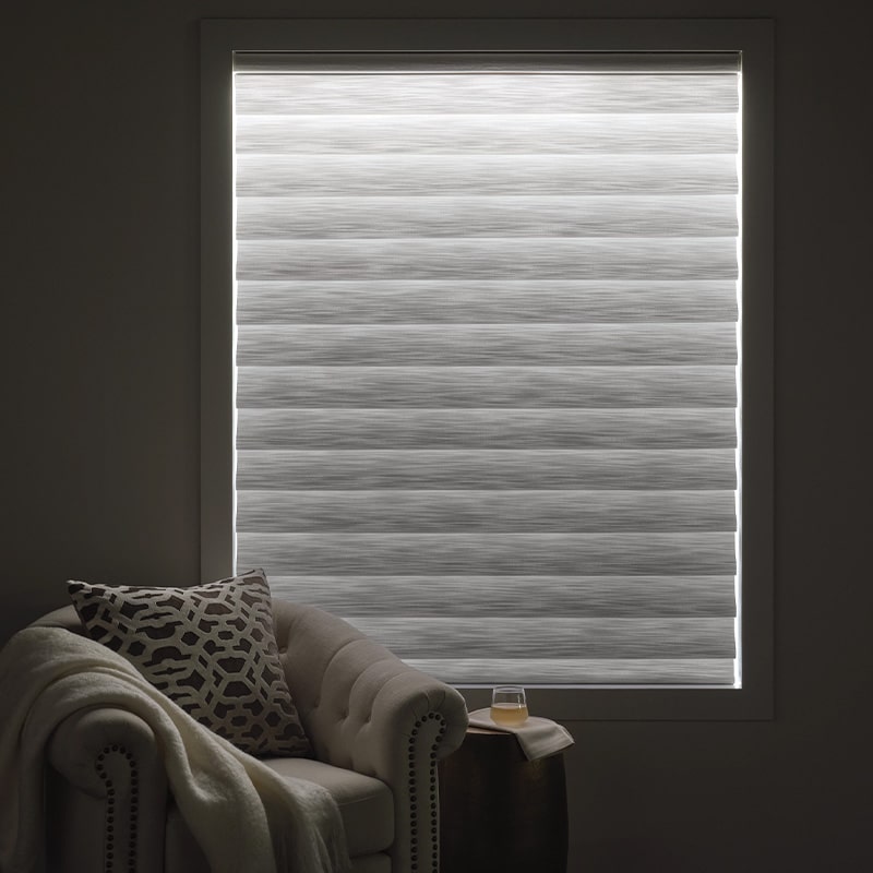 Bright, modern window blind with horizontal stripes controlling natural light, creating a calm and inviting atmosphere inside the living room.