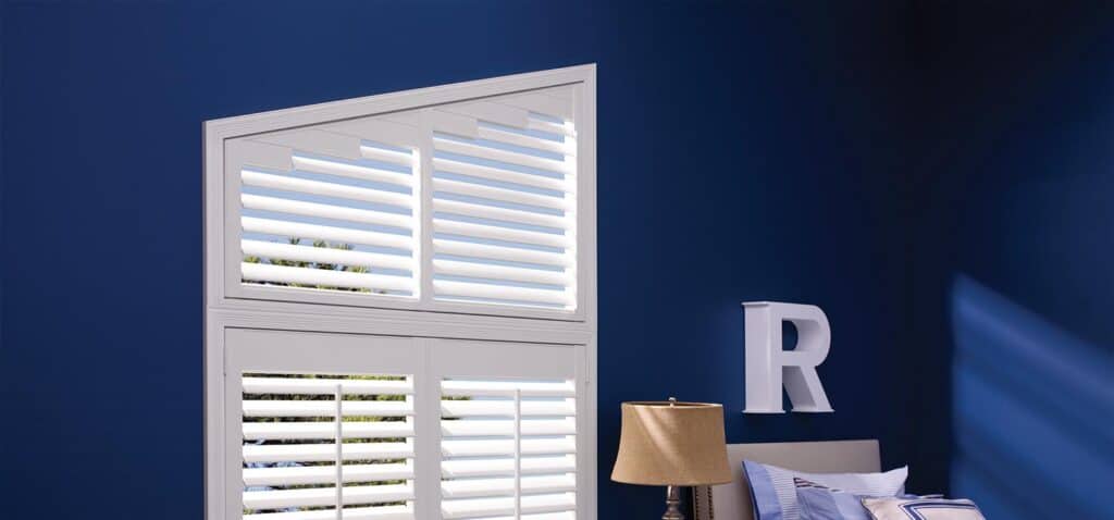Bright, stylish window shutters in a cozy bedroom with blue walls, modern decor, and soft lighting.