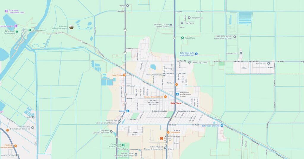 Map of the city showing streets, parks, and transportation routes with a sunset sky in the background.