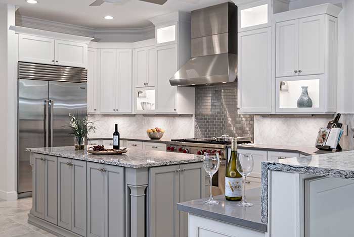 Modern white kitchen with stainless steel appliances and elegant cabinetry.
