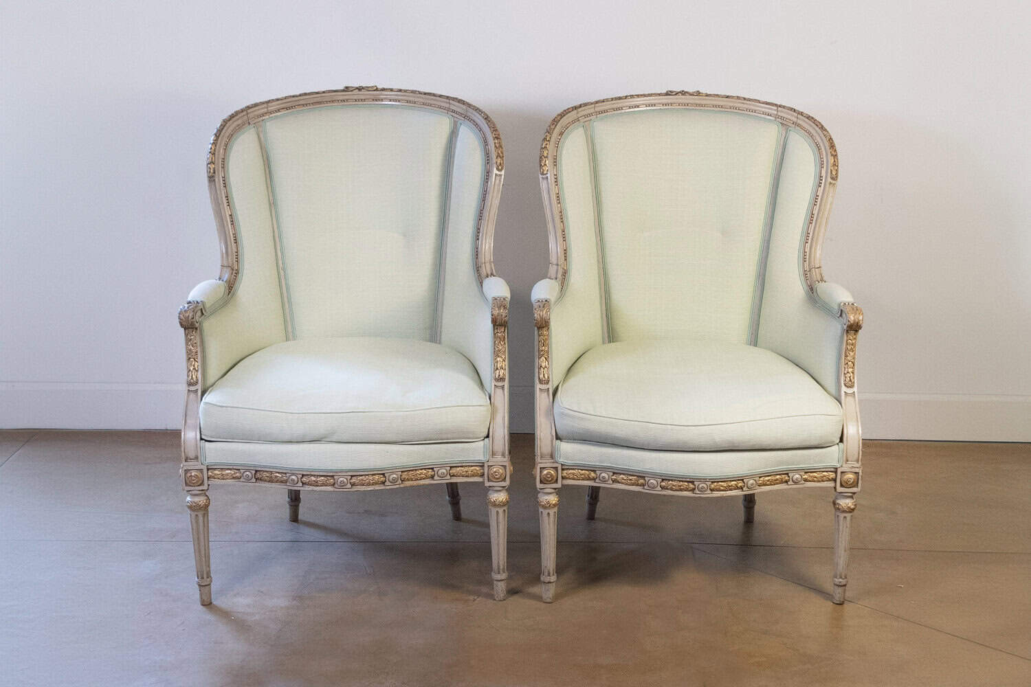 Pair of French Louis XVI Style 1900s Painted and Parcel-Gilt Bergères Chairs - JAA