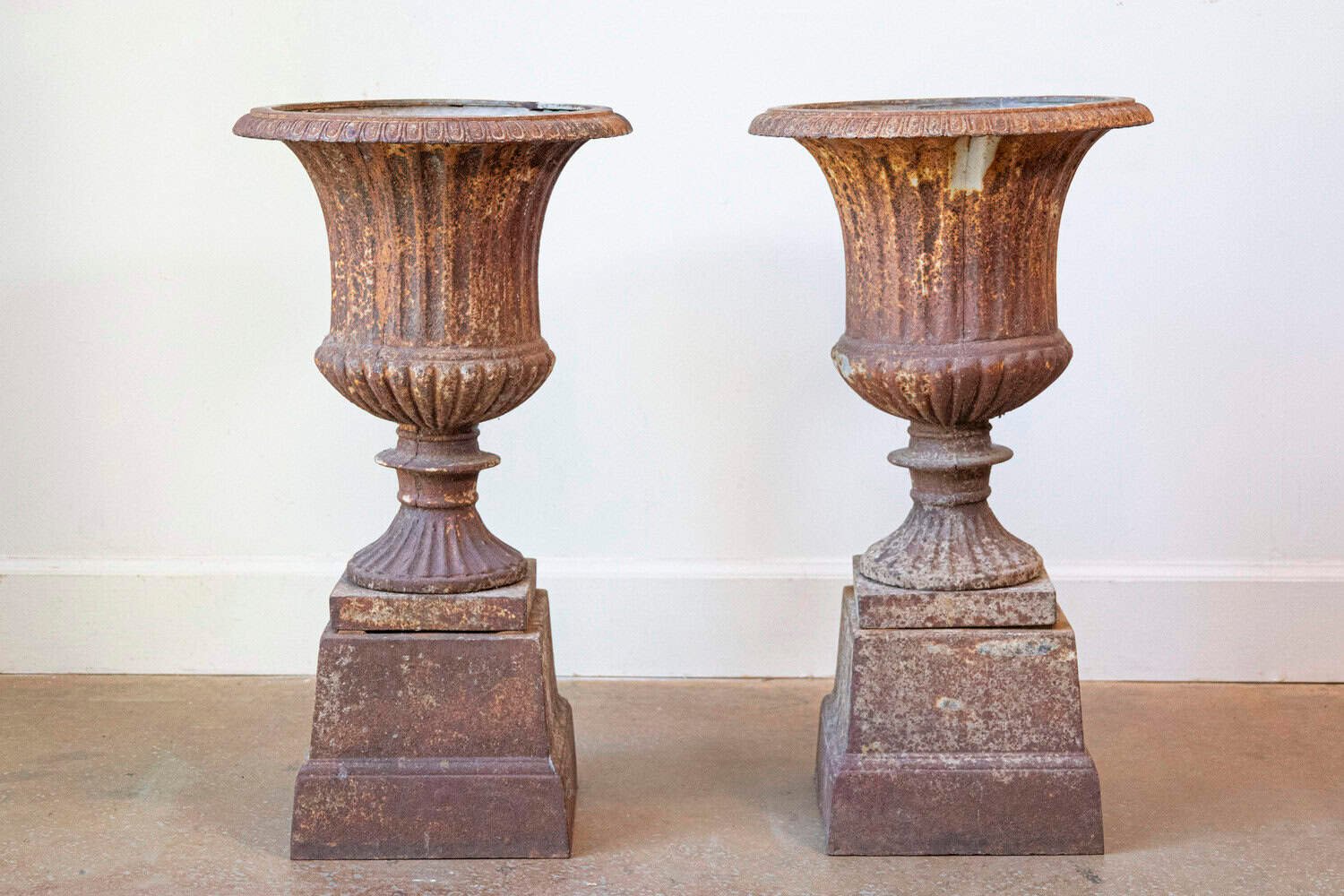 Pair of French 19th Century Iron Médicis Vases on Stepped Pedestals with Patina - JAA