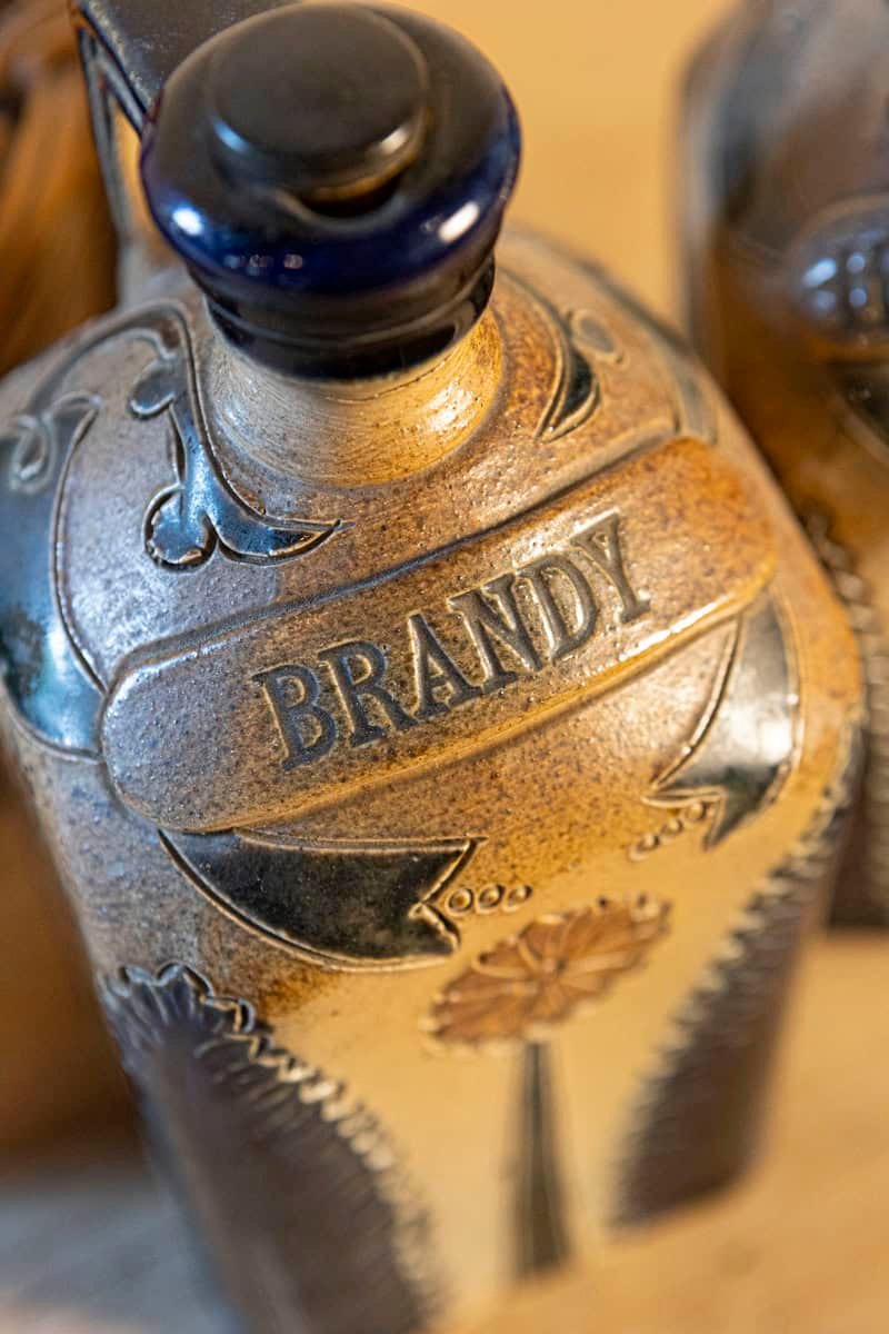 Two Victorian English Pottery Decanters in Tantalus-Inspired Wicker Basket - JAA