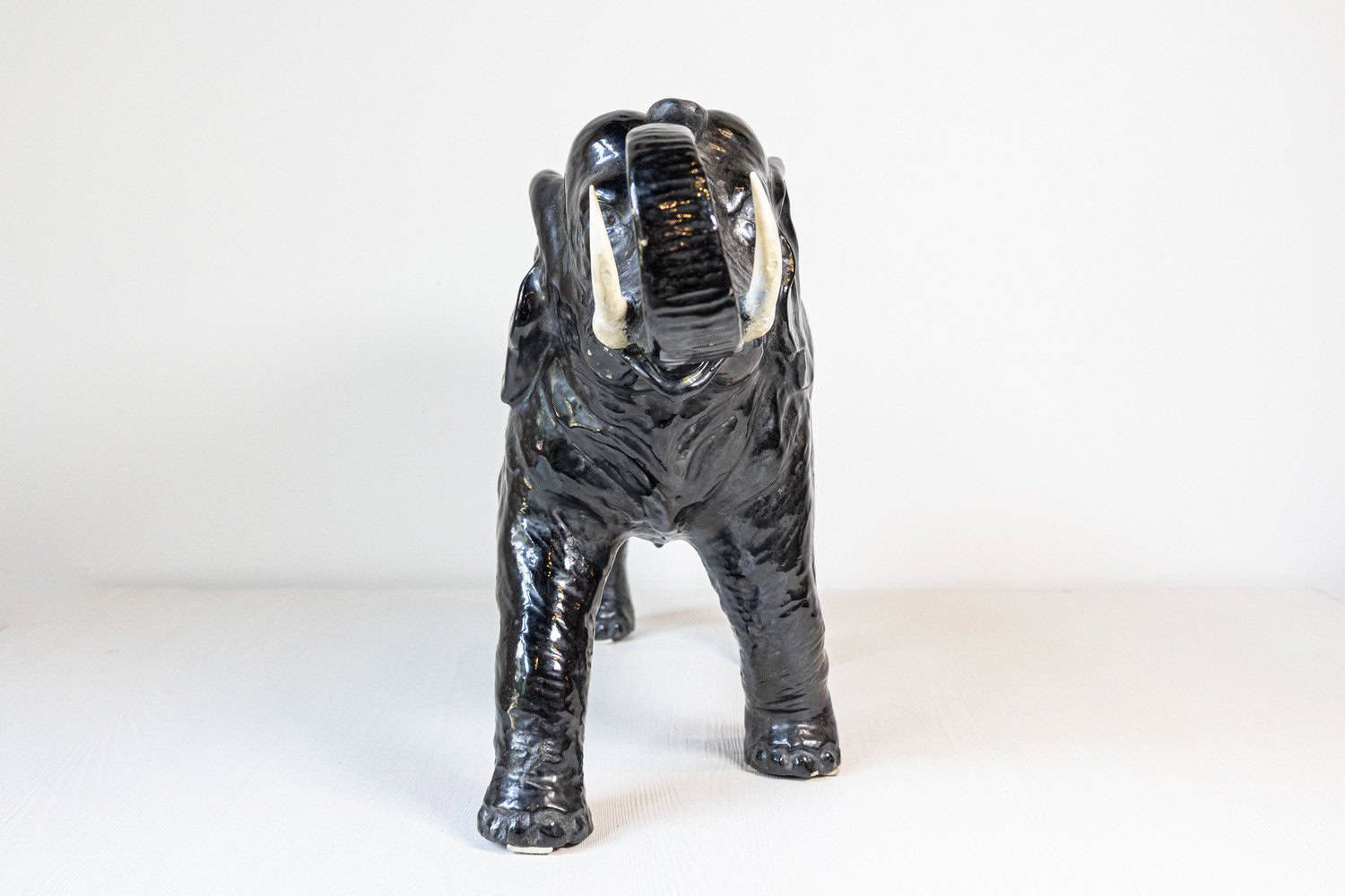 Vintage Italian Black Glazed Ceramic Sculpture of a Walking Elephant, Trunk Up - JAA