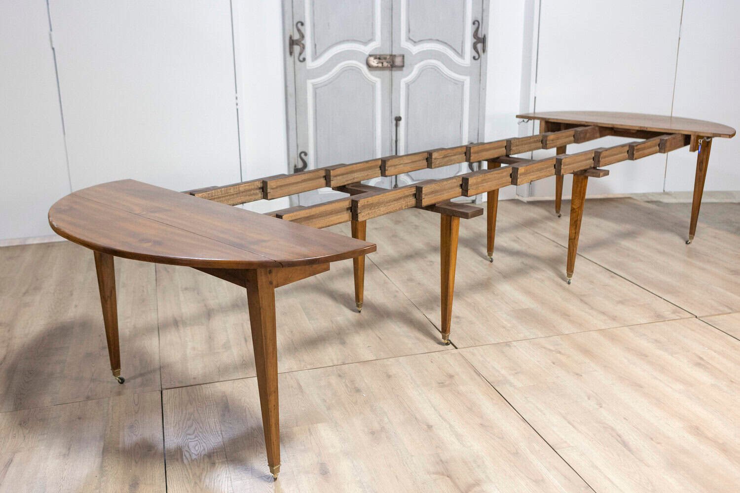 20th Century French Walnut Extension Dining Table With Five Leaves, Tapered Legs on Casters - JAA