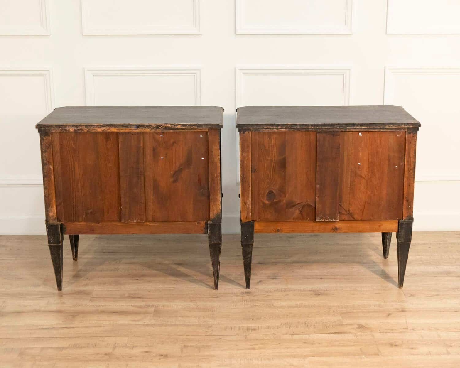 A pair of black Gustavian-style chests of drawers. - JAA