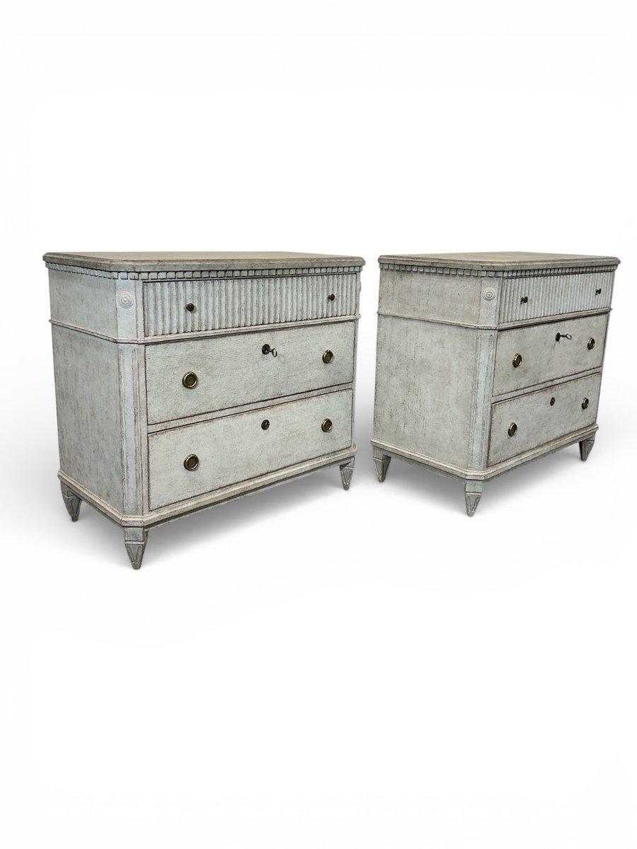 A pair of Gustavian-style chests of drawers in two shades of grey. - JAA