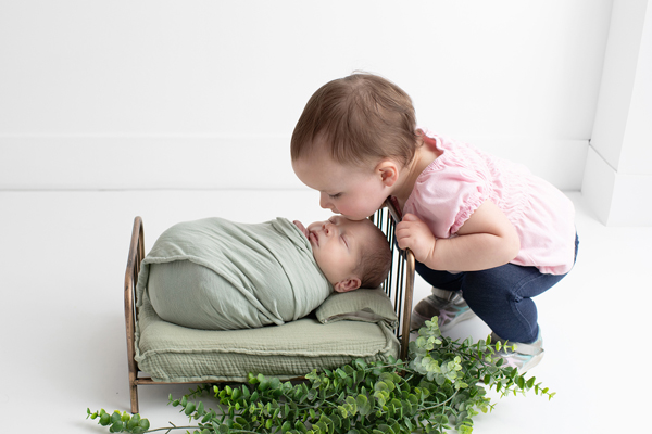 protective toddler with newborn sibling