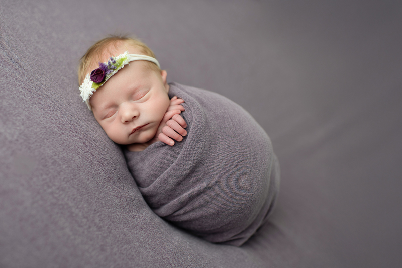 newborn baby in purple swaddle in my maryland studio
