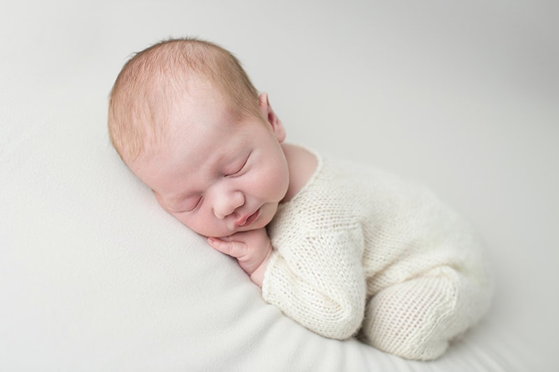beautiful knitted romper on newborn baby boy