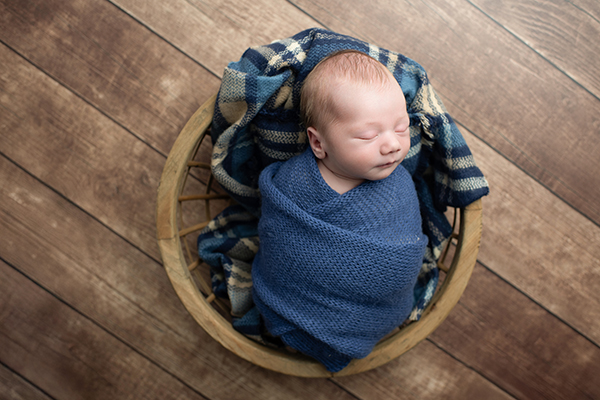 Studio newborn photography Frederick MD baby posed safely in prop