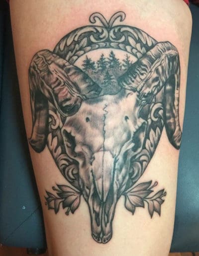 Jesse Britten Tattoo, St Augustine FL,. Ram skull tattoo with forest scene and ornate frame.