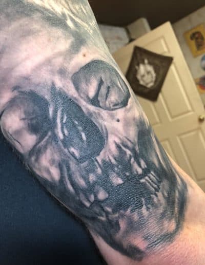 Jesse Britten Tattoo, St Augustine FL. Skull tattoo on forearm, black and gray ink tattoo.