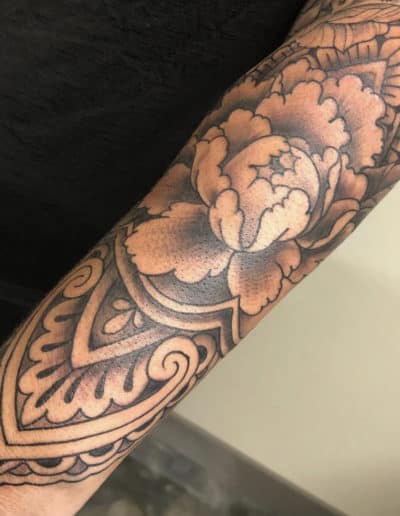 Jesse Britten Tattoo, St. Augustine, FL Peony flower tattoo with mandala design on arm.