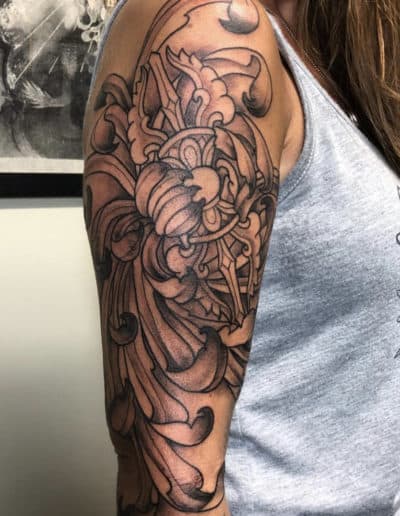 Jesse Britten Tattoo, St. Augustine, FL Detailed black and gray Japanese flower tattoo on an arm.