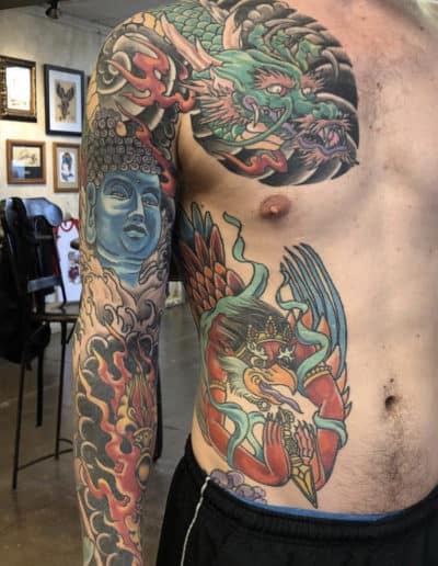 Jesse Britten Tattoo, St. Augustine, FL Japanese tattoo featuring a dragon, Buddha, and mythical bird design.