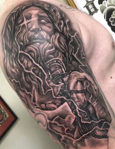 Jesse Britten Tattoo, St. Augustine, FL Gladiator tattoo with Zeus and lightning. Black and gray ink.