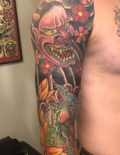 Jesse Britten Tattoo, St. Augustine, FL Japanese tattoo sleeve with Oni mask, frog, and cherry blossoms.