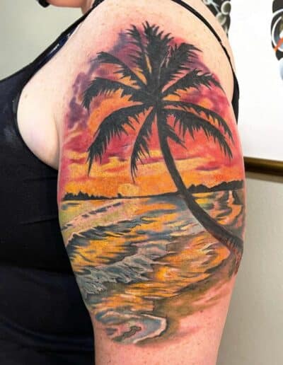 Jesse Britten Tattoo, St. Augustine, FL Sunset beach tattoo with palm tree on arm