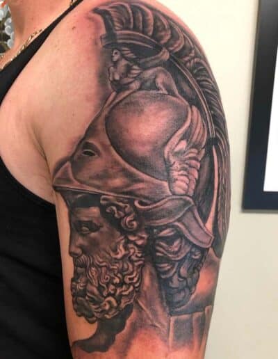 Jesse Britten Tattoo, St. Augustine, FL Detailed black and gray tattoo of a Greek warrior on an arm.