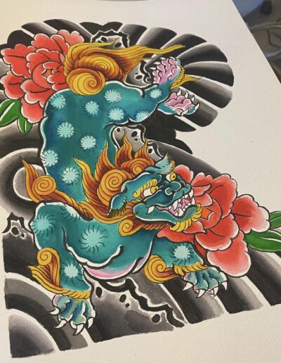 Jesse Britten Tattoo, St. Augustine, FL Japanese tattoo art: A vibrant blue Foo Dog with red peonies and traditional black and grey background.