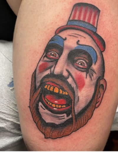 Jesse Britten Tattoo, St. Augustine, FL Traditional tattoo of a scary clown with a red and blue top hat.
