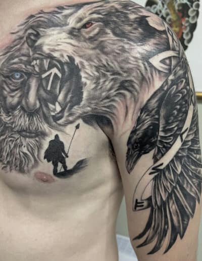 Jesse Britten Tattoo, St. Augustine, FL Chest tattoo of Odin, wolf, raven, and warrior silhouette.