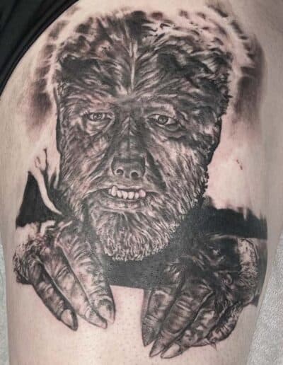 Jesse Britten Tattoo, St. Augustine, FL Black and grey tattoo of the Wolfman, a classic horror film monster with hairy face and hands.