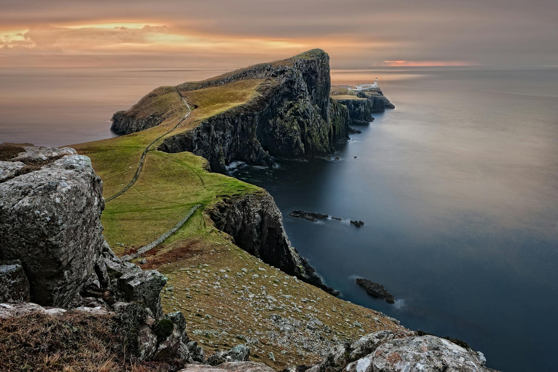 green and brown mountain cliffs near ocean