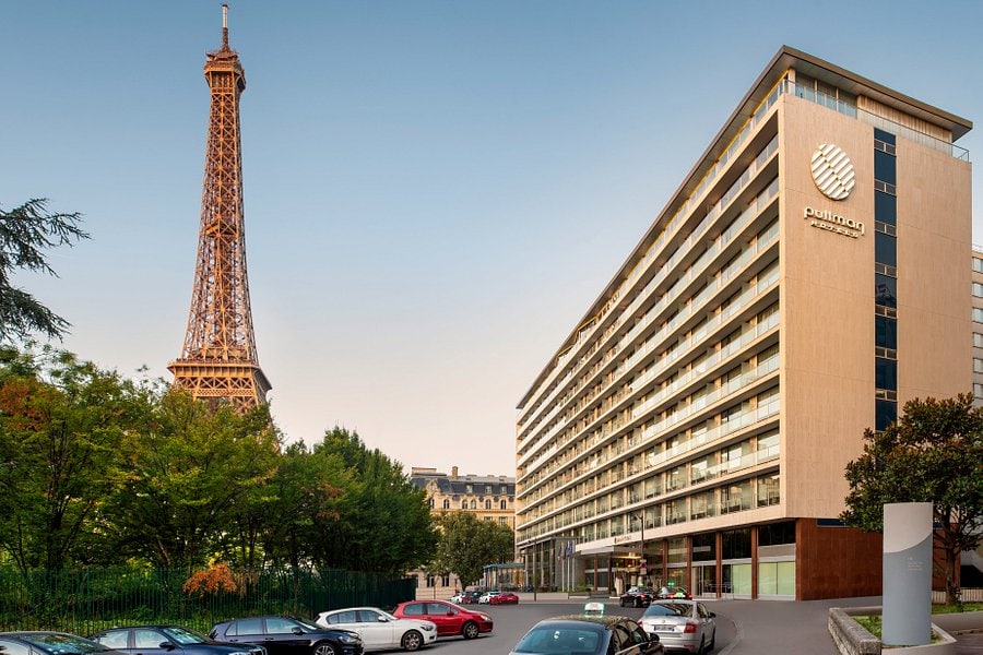 Eiffel Tower view with Pullman Hotel in Paris, showcasing a blend of iconic architecture and modern accommodations perfect for travelers exploring the city.