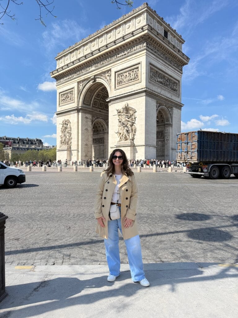 Eiffel Tower in Paris with a solo female traveler posing in front, showcasing a must-visit landmark for travelers exploring Paris alone.