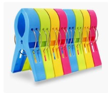 Blue, yellow, pink, and green plastic swim fins with adjustable straps for water sports and snorkeling activities.