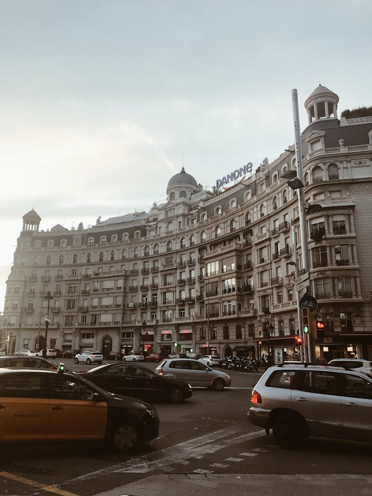 Elegant European hotel in Madrid, Spain with historic architecture and busy city streets, ideal for travel lifestyle and urban adventure photography.