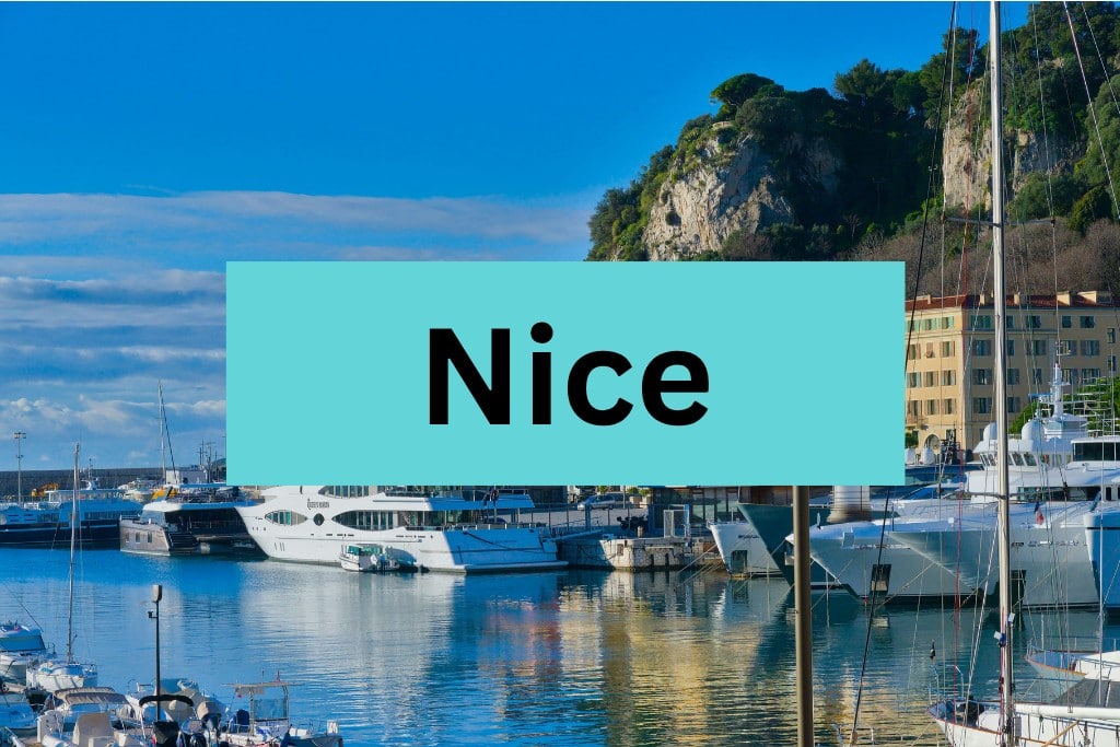 Beautiful marina with yachts and boats docked, scenic cliffs in the background, perfect for a France travel adventure.