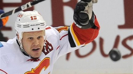 Dr. John F. Murray with NHL All-Star Olli Jokinen celebrating his 1,000th game