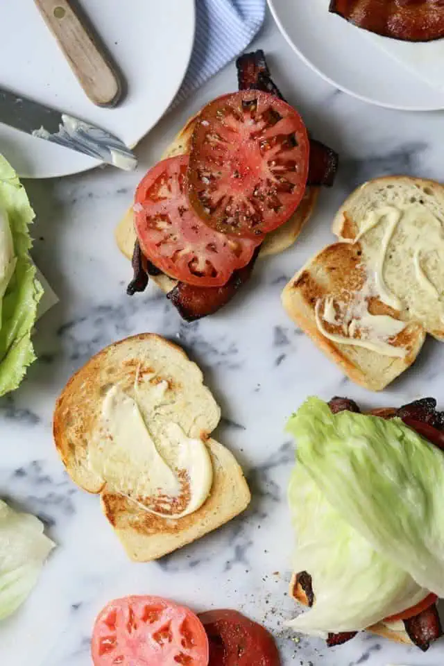making a blt with bacon, tomato, and lettuce 