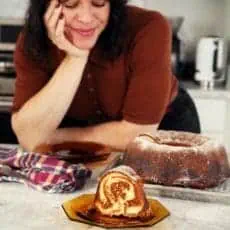Joy looking at a slice of bundt cake.